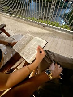 a person sitting on a chair reading a book