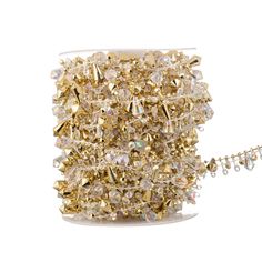 a spool of gold colored crystal beads on a white background