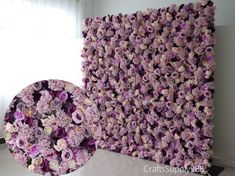 there is a large flower wall in the room with it's purple and white flowers