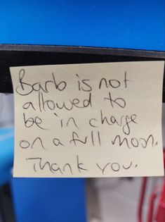 a handwritten note attached to a shelf