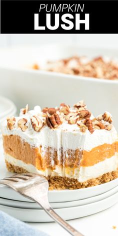 a slice of pumpkin lush cake on a plate with a fork and the rest of the pie in the background