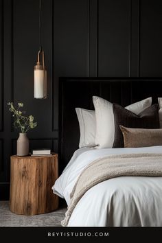 a bedroom with black walls and white bedding, wooden side table and plant in the corner