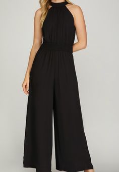 Take a daring leap into style with the Natalie Jumpsuit in sleek black. Featuring a wide leg for a bold look, a waist-smocked design for a flattering fit, and a halter neckline with a back tie for added detail. Made with 100% polyester, this jumpsuit is perfect for taking risks and making a statement. Taking Risks, Halter Jumpsuit, Live Fit, Bad Habit, Jumpsuit Black, Stunning Outfits, Leg Design, Wide Leg Denim, Solid Dress