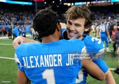 two football players hugging each other on the field