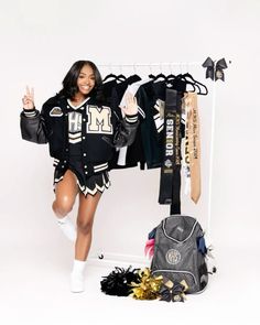 a woman standing in front of a rack with hockey gear