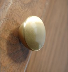 a close up of a door knob on a wooden surface