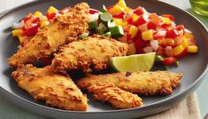 a plate full of fried chicken and vegetables