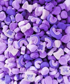 purple and white marshmallows are piled together