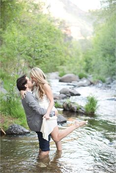 a man and woman are standing in the water