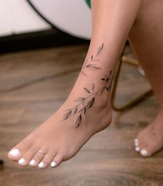 a woman's foot with a tattoo on it