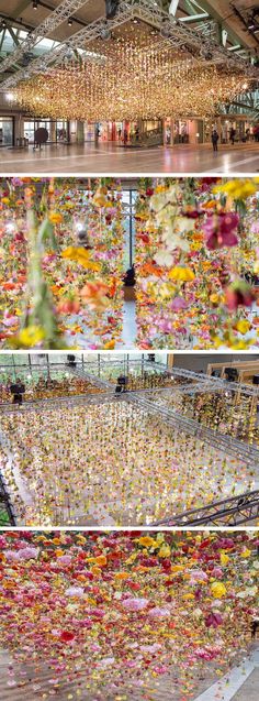 the inside of a building with lots of flowers hanging from it