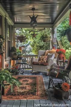 the porch is covered with plants and potted plants