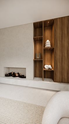 a living room filled with furniture and a fire place next to a wall mounted shelf