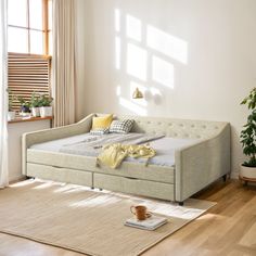 the daybed is made up and ready to be used as an office or living room