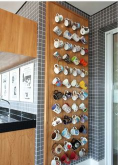 a wall mounted tea cups and saucers in a kitchen