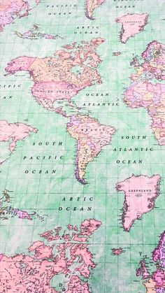 an old world map with pink and green paint on the paper, showing countries in different colors