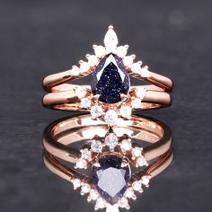 ►Made of 925 solid sterling silver ►Rose Gold Plating ►Accented with simulated diamonds (CZ) ►Average band width: 1.7 mm ►Sold as a two-piece set ►Fit is true to size ►This ring is inspired by the Great Rift nebula (shown above). The glittering sandstone resembles the stars on a dark night. A beautiful alternative for a wedding band, this ring will stand out amongst the crowd of standard wedding bands. ►Sandstone is known for being a rejuvenating stone that helps you feel recharged and alive bec Anniversary Sapphire Ring In Rose Gold Sterling Silver, Sapphire Rose Gold Ring Jewelry, Rose Gold Sapphire Ring Jewelry, Rose Gold Sapphire Ring With Diamond Accents For Gift, Rose Gold Cubic Zirconia Sapphire Ring Gift, Rose Gold Sapphire Jewelry For Anniversary, Rose Gold Sapphire Ring With Vvs Clarity For Wedding, Gift Rose Gold Sapphire Ring With Cubic Zirconia, Rose Gold Sapphire Jewelry With Center Stone