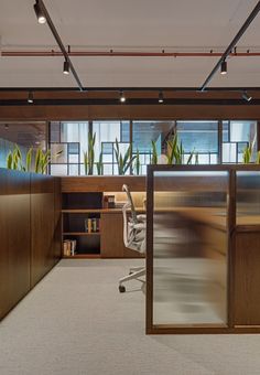 an office with wooden walls and glass doors