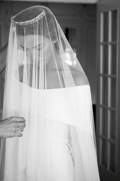 the bride is getting ready to walk down the aisle in her wedding dress and veil