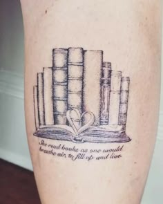 a tattoo with books and a heart on it