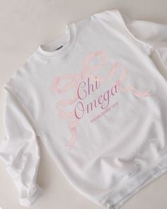 a white sweatshirt with pink ribbon on the chest that says, ohi onega