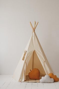 a teepee tent with two stuffed animals in it