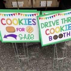 two signs that say cookies for sale and drive thru cookie booth