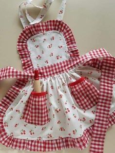 a red and white checkered dress with an apron