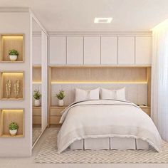 a white bed sitting next to a wooden headboard in a room with two planters on either side of the bed