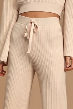 Get cozy on the couch in the Lulus Snuggly Style Cream Ribbed Knit Wide-Leg Pants! These cold-weather essential pants are shaped from ribbed knit and feature a high-waisted fit with decorative drawstring detail, and relaxed-fit, wide pant legs that end in ankle-grazing cropped hems. Pair with the matching sweater for a complete look! Fit: This garment fits true to size. Length: Mid-calf length. Size small measures 35.5" from waist to hem. Waist: Fitted - elastic waist allows stretch. Hip: Fitted Essential Pants, What Is Trending Now, Cream Pants, Drawstring Detail, Matching Sweaters, Wide Pants, Getting Cozy, Cropped Sweater, Stretchy Fabric