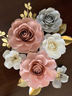 paper flowers are arranged on a wooden table