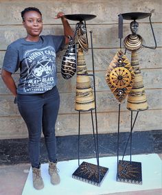 a woman is standing next to some decorative items