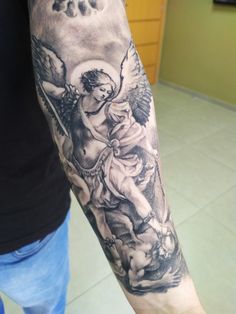 a man's arm with an angel tattoo on it