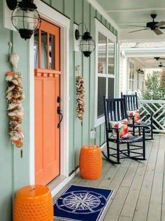 an orange and blue porch with rocking chairs