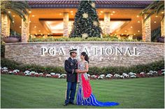 a man and woman standing in front of a building