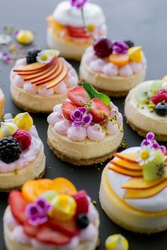 small desserts with fruit and whipped cream toppings on a black tablecloth, ready to be eaten