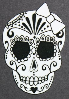 a white and black sugar skull on a gray background