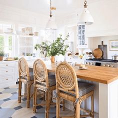 a kitchen with an island and chairs in it