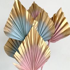 three pink and blue paper fan shaped vases