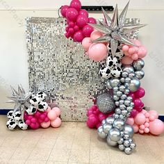 a balloon arch with pink, silver and black balloons