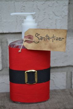 a red container with a bottle of sanitizer in it and a tag on the top