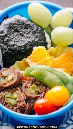 a blue bowl filled with different types of food