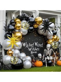 a halloween wreath made out of balloons and skeleton decorations