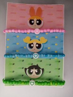 the powerpuff girls pencil cases are lined up on top of each other,