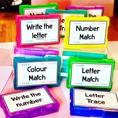 four different colored plastic containers with writing on them and one has the words write the letter match