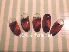 four different types of nail polish sitting on top of a striped tablecloth with the words nails patrick written above them