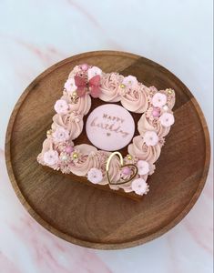 a heart shaped cake sitting on top of a wooden plate