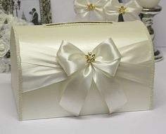 a white purse with a large bow on it