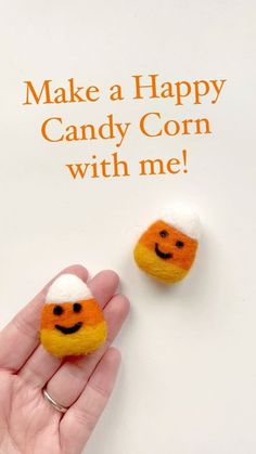 someone is holding two small candy corns in their hand with the caption make a happy candy corn with me