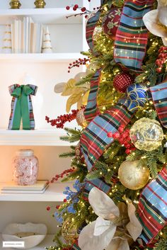 a decorated christmas tree with red, white and blue ribbons